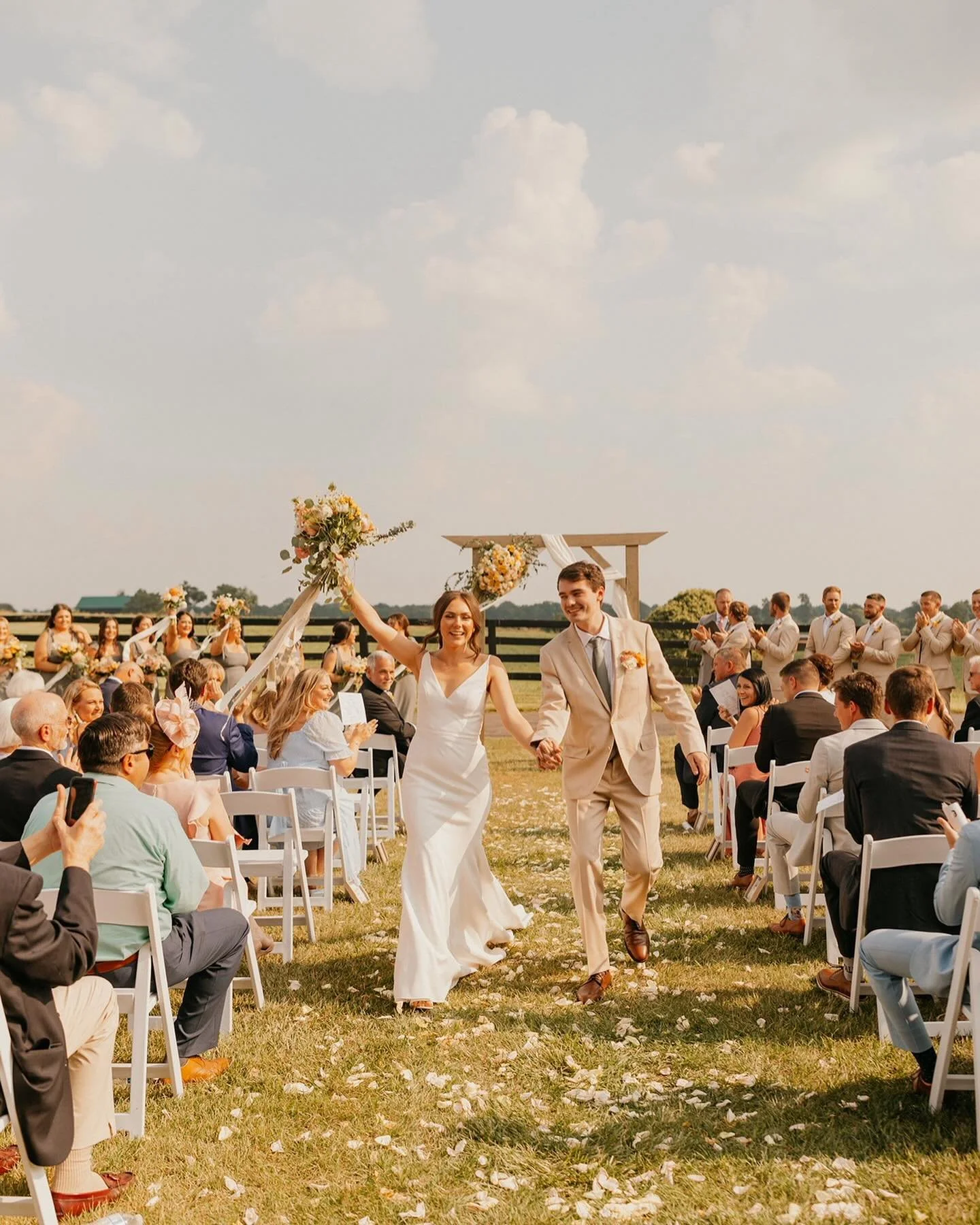 Bride and groom celebrating as they walk back down the aisle